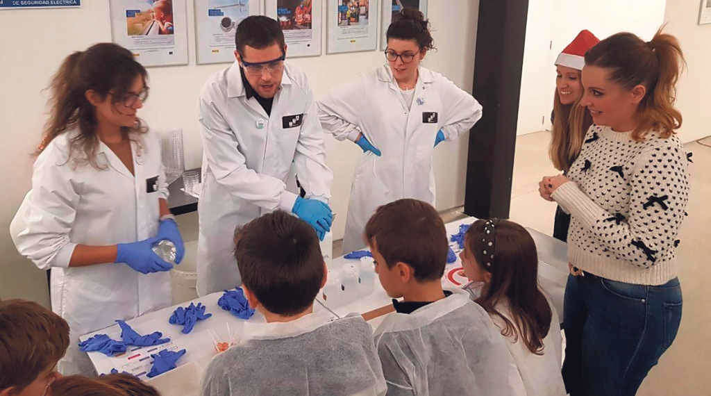 Crianzas aprendendo nun laboratorio da man de investigadores e investigadoras (Foto: Europa Press).