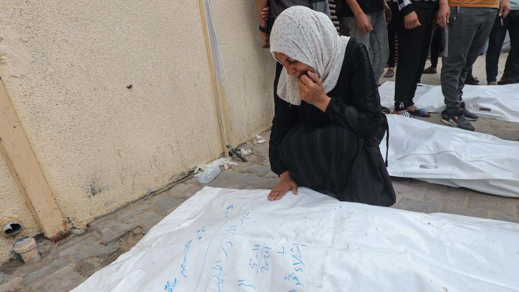 Unha muller chora xunto aos corpos dos palestinos mortos nun ataque israelí no centro da Faixa de Gaza o 11 de maio. (Foto: Omar Naaman / dpa vía Europa Press).