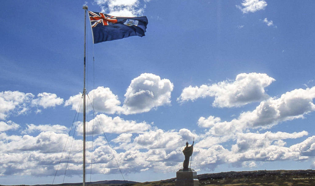 Falkland Islands flag flies over memorial monument in Port Stanley, capital of the Falkland Islands, erected by the islanders to commemorate their liberation in the brief undeclared war between Argentina and Great Britain in 1982 over control of the Falkland Islands (Islas Malvinas).